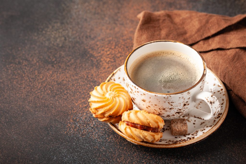 Black coffee and cookies on a table